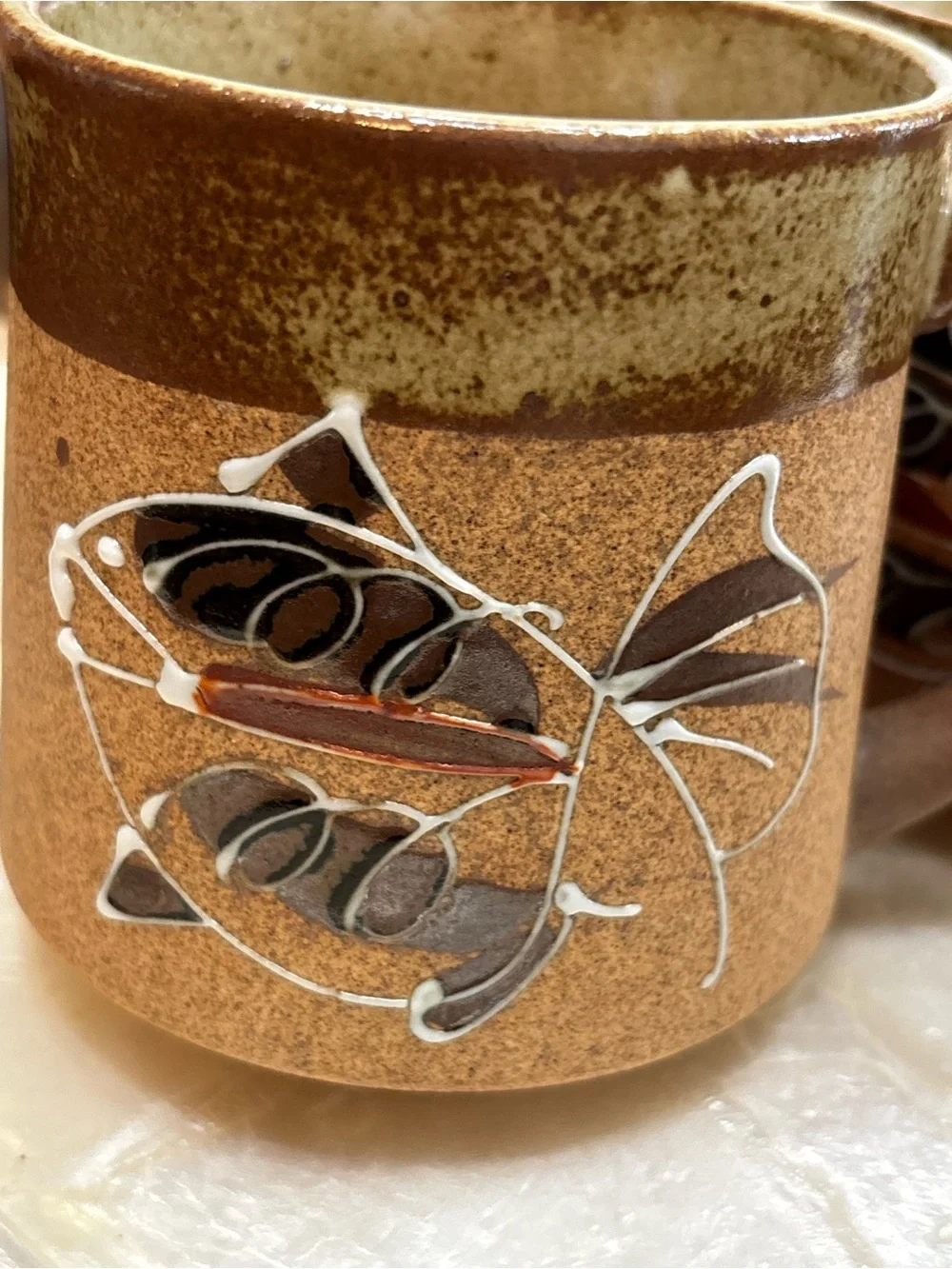 Three vintage stoneware pottery mugs with hand painted fish